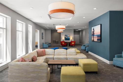 a living room with a large couch and chairs at Hilton Garden Inn Pascagoula in Pascagoula