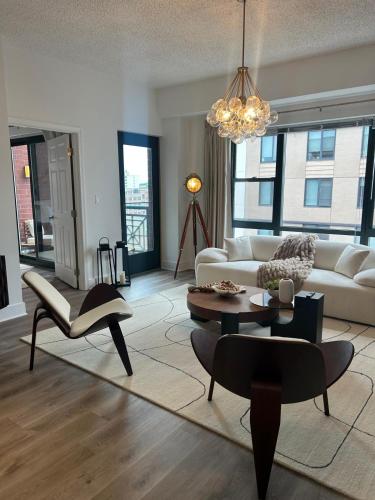 a living room with a couch and a table at The Monroe Elegant 2br2ba Downtown Stamford in Stamford