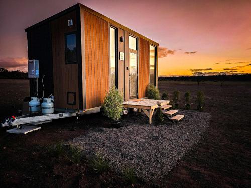 a tiny house sitting on a trailer in a field at Bec's Place by Tiny Away