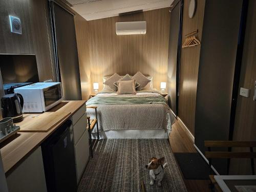 a small bedroom with a bed and a tv at Bec's Place by Tiny Away 