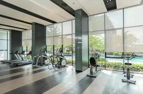a gym with a lot of chairs and windows at The Base - Rama 9 by Sumaq Property in Bangkok
