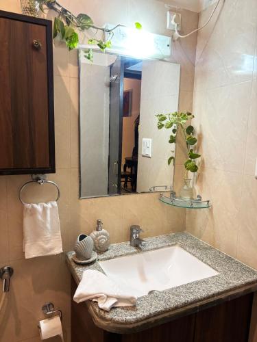 a bathroom with a sink and a mirror at Otla - A Heritage Boutique Hotel, Jaipur in Jaipur