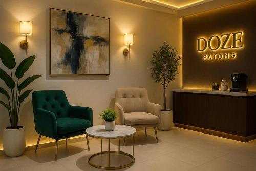 a waiting room with two chairs and a table at Doze Patong in Patong Beach