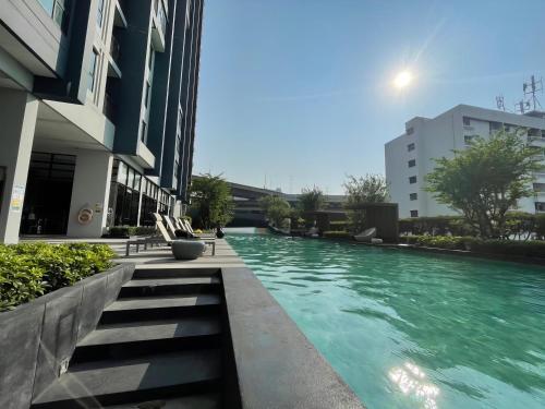 a swimming pool in the middle of a building at The Base - Rama 9 by Sumaq Property in Bangkok