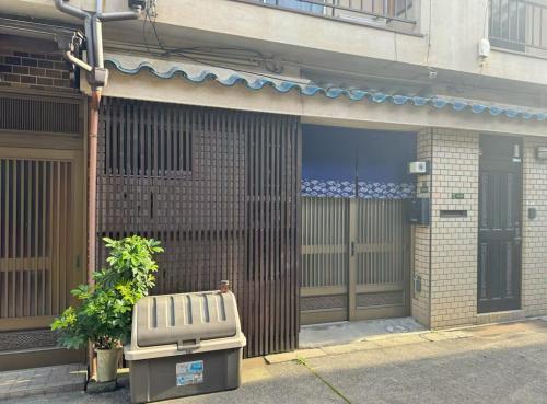 a building with a bench in front of a door at 盛-大正 in Osaka