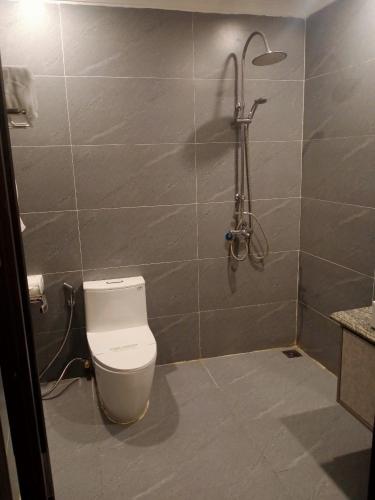 a bathroom with a toilet and a shower at Sen plaza Hotel in Yên Thành