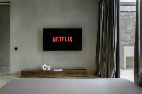 a television on a wall in a bedroom at Predmet Babakan Canggu Bali in Dalung