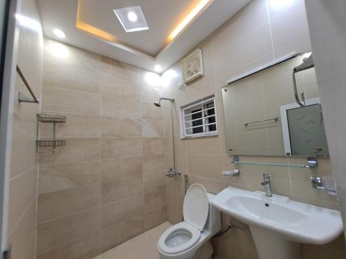 a bathroom with a toilet and a sink at The Guest House Islamabad G-13 in Islamabad