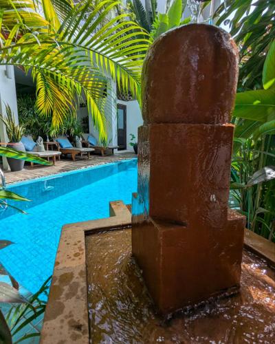 a water fountain in front of a swimming pool at Family Style 3-Bedroom Suite by Baahu Villa in Siem Reap