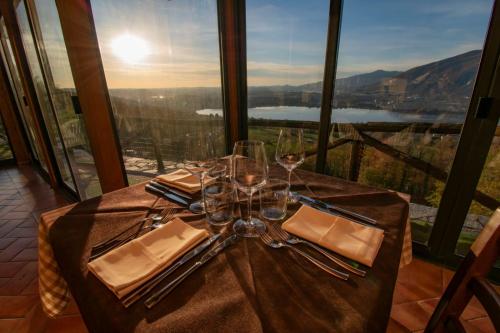 a table with wine glasses and a view of a mountain at Antica Locanda La Tinara del Belvedere - Romantic Dreams - in Galbiate