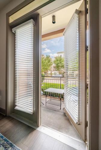 a sliding glass door with a view of a balcony at Downtown Houston Retreat with Free Parking in Houston