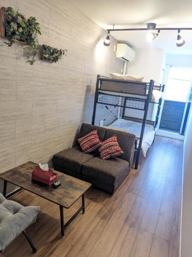 a living room with a couch and a bunk bed at -Summer Escape- Just 15 min from Haneda Airport, Max 3 in Tokyo