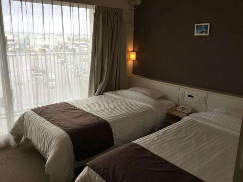 Katil atau katil-katil dalam bilik di Hotel Gran View Garden Okinawa