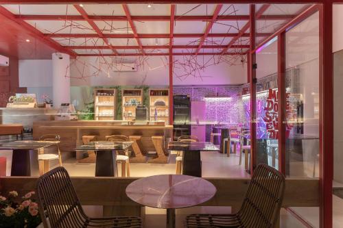 a restaurant with tables and chairs in a room at Dali Upland International Youth Hostel, near the south gate of the ancient city ,5 mins walk to the old town, Close to Er Hai Lake, convenient payment and visa cards are accepted in Dali