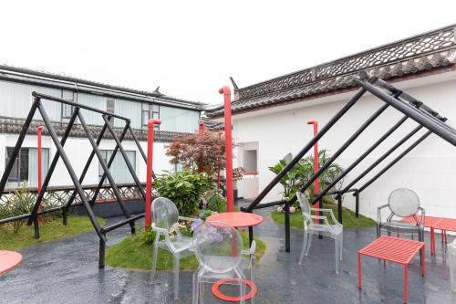 a group of chairs and tables on a patio at Dali Upland International Youth Hostel, near the south gate of the ancient city ,5 mins walk to the old town, Close to Er Hai Lake, convenient payment and visa cards are accepted in Dali
