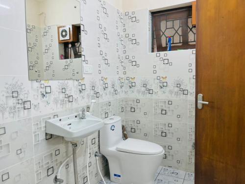 a bathroom with a toilet and a sink at Good stay TNagar in Chennai