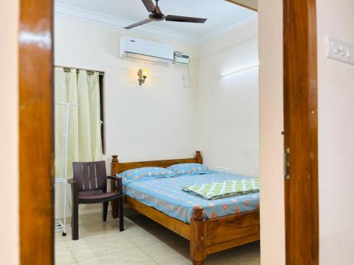 a bedroom with a bed and a chair at Good stay TNagar in Chennai