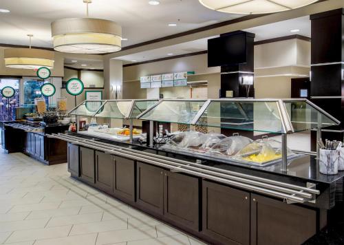 a buffet line in a restaurant with food at Embassy Suites by Hilton St Louis Airport in Bridgeton