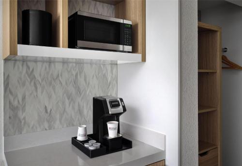 a kitchen with a microwave and a coffee maker at Hilton Garden Inn Tampa East Brandon in Tampa