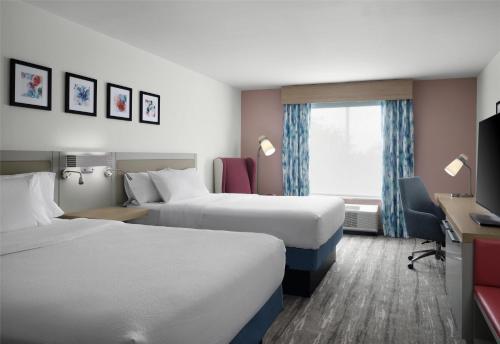 a hotel room with two beds and a window at Hilton Garden Inn Tampa East Brandon in Tampa