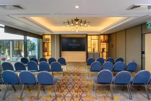 a conference room with chairs and a projection screen at The Vista At Hilton Tel Aviv in Tel Aviv