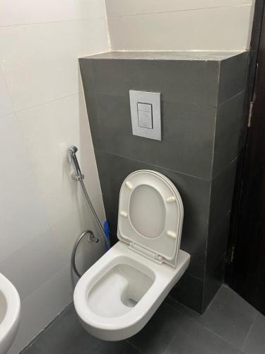 a bathroom with a white toilet and a sink at The SUNset, Zirakpur 3bhk flat for families only in Zirakpur