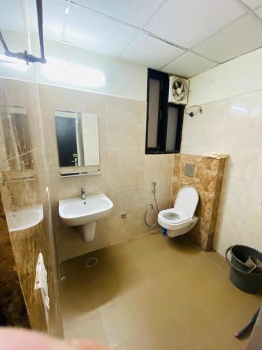 a bathroom with a sink and a toilet at The SUNset, Zirakpur 3bhk flat for families only in Zirakpur