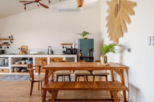 a dining room with a wooden table and chairs at SeaSalt BeachFront Holiday Home, Private pool, 2 Bedroom house in Chaloklum