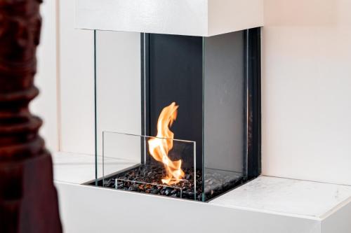 a fireplace with a fire in it at Rosemont House Luxury BnB Suites in Noojee