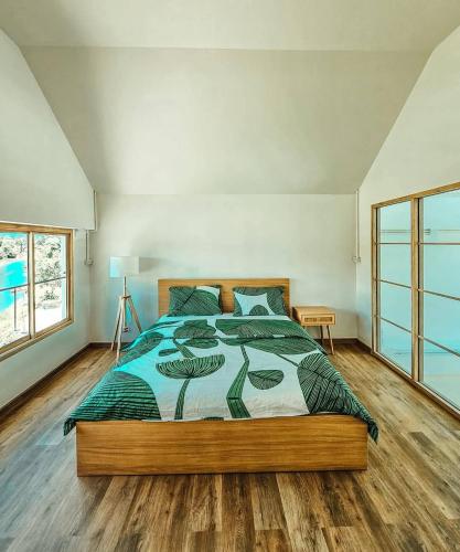 a bedroom with a large bed in a room at Tara Vela in Chumphon