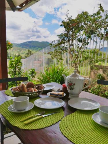 a table with a teapot and bowls of food on it at Mi Casita in Samaipata