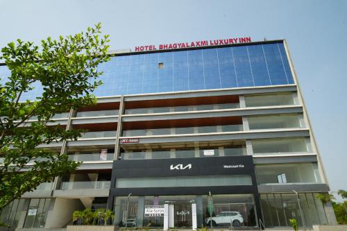 a building with a kia sign on top of it at Hotel Bhagyalaxmi Luxury Inn in Ahmedabad