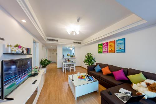 a living room filled with furniture and a tv at Rose Garden Residences in Hanoi