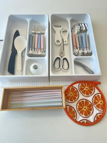 a drawer filled with utensils and a box of cutlery at Kukuna外房 in Mobara