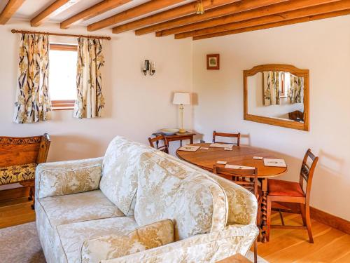a living room with a couch and a table at The Milking Parlour in Tutbury