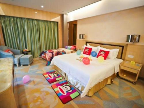 a bedroom with a bed and a living room at Shanghai Fuyue Hotel in Shanghai