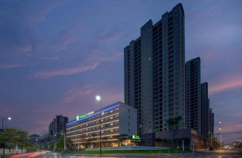 a large building in a city at night at Holiday Inn Express Jingdezhen Ancient Town By IHG in Jingdezhen