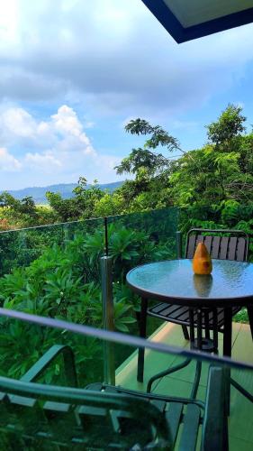 a table with a fruit sitting on top of a balcony at The Bukit Resort Langkawi in Kampung Padang Masirat