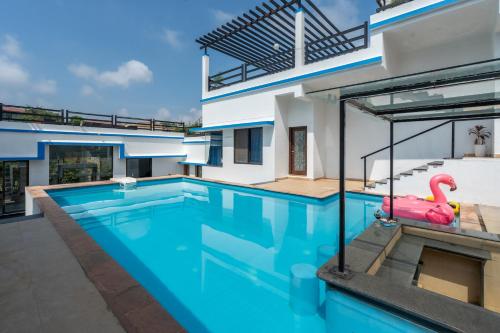 a swimming pool with a pink float in the middle of a house at CASA DIOS Luxury Villas in Khandala