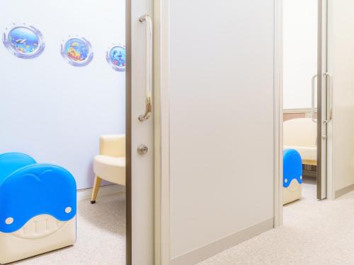 a childrens room with a mirror and a crib at Mikazuki Sea-Park Hotel Katsuura in Katsuura