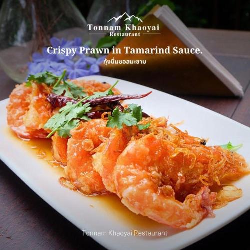 a plate of food with shrimp on a table at khaoyai lumtakong hotel in Mu Si