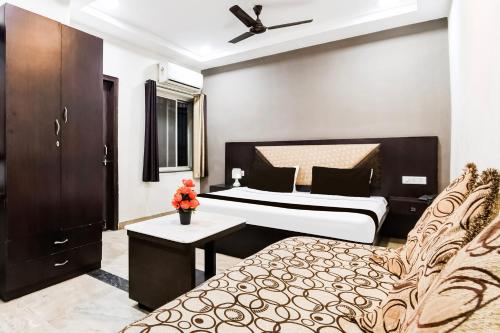 a hotel room with a bed and a couch at Hotel O Raipur City Center Formerly Hotel Edge in Raipur