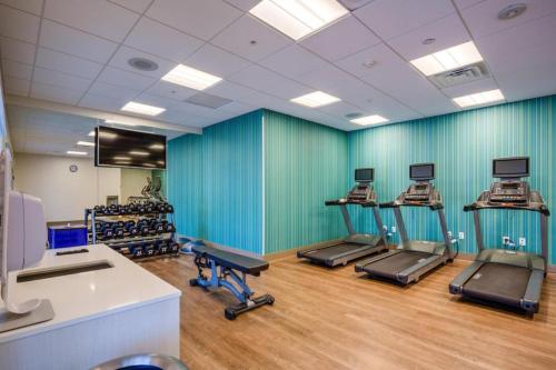 a gym with several treadmills in a room at Holiday Inn Express & Suite Milroy - Reedsville By IHG in Burnham