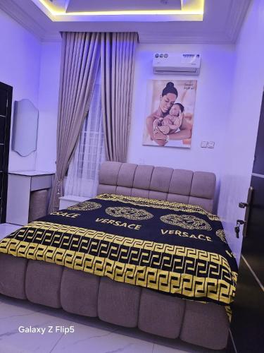 a bedroom with a bed and a picture of a baby at Luxury 3 bed rooms villa in Lekki