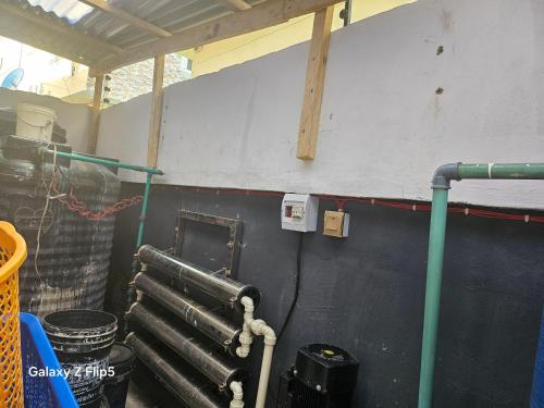 a room with a water heater and pipes on a wall at Luxury 3 bed rooms villa in Lekki