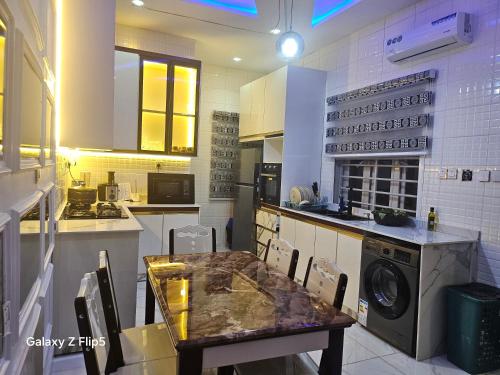 a kitchen with a table and a washing machine at Luxury 3 bed rooms villa in Lekki