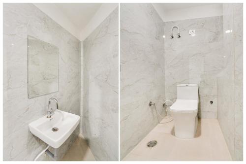 a white bathroom with a toilet and a sink at Hotel O Heaven in Gwalior