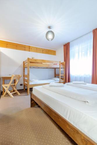 a bedroom with two beds and a bunk bed at Resort 7 Crai - Cabana Craiul Crailor in Zărneşti