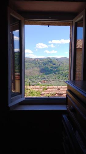 a window with a view of a field through it at Da Nonno in Montegiovi