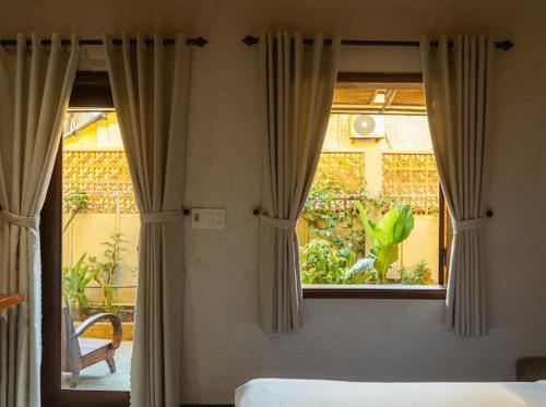 Postel nebo postele na pokoji v ubytování Aki Eco-Villa Hội An